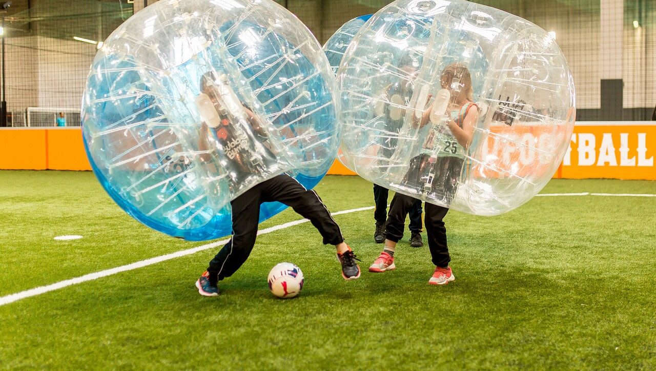 Kinder spielen Bubble Soccer auf einem Fussballfeld in Zürich – BubbleBall Schweiz mieten